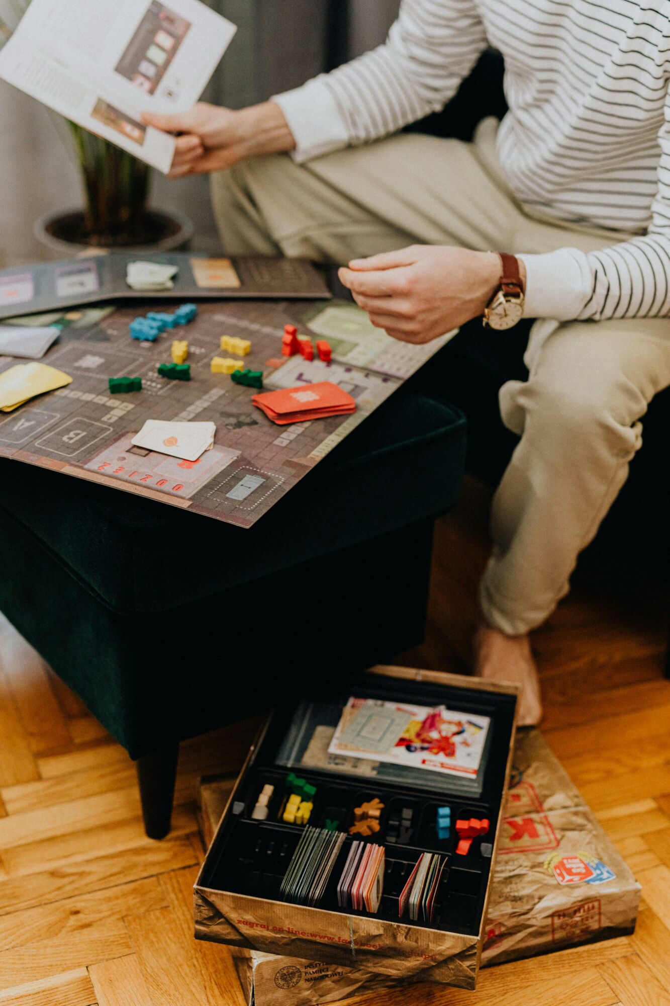 Casual indoor scene of a man enjoying a board game, highlighting leisure and strategy.